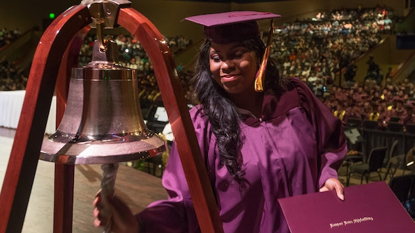 Apprentice Tiffani Brown Powell rings the Apprentice School bell as she graduates