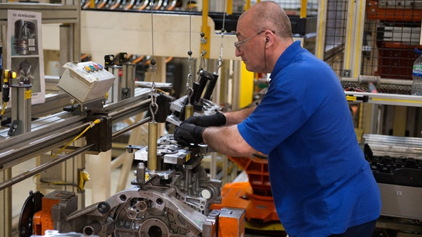 An employee at Ford39s Dagenham England facility works on assembly of a diesel engine Ford designs and engineers gasoline and diesel engines in the UK that go into half of all Ford vehicles