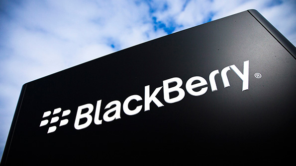 The BlackBerry wordmark on a black sign against a cloudy sky