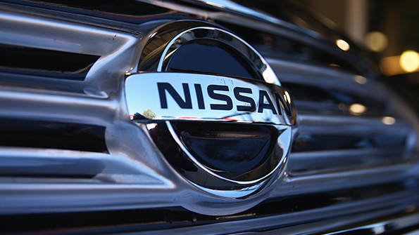 The Nissan logo on a vehicle grille