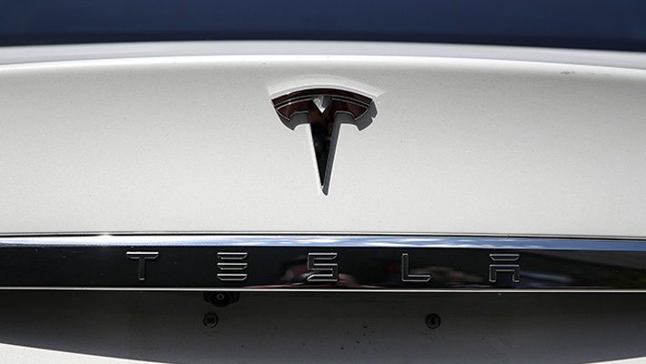The Tesla logo and wordmark on the rear of a Model S.