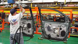 A worker assembles car doors at a Ford plant in Chicago. A worker assembles car doors at a Ford plant in Chicago.