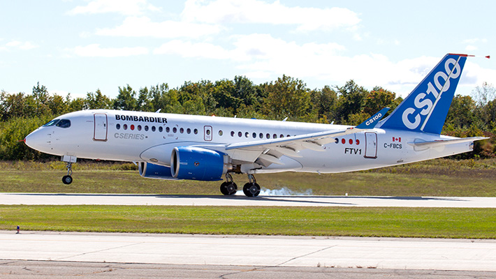 A Bombardier C series plane takes off on a runway.