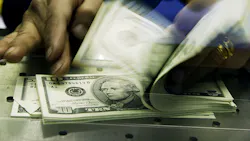 A stack of cash, mostly in $5 and $10 bills. A stack of cash, mostly in $5 and $10 bills.