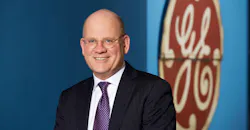 GE CEO John Flannery with GE logo GE CEO John Flannery with GE logo