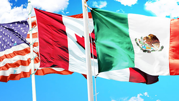 The flags of the United States, Canada and Mexico.