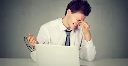 Worker rubbing eyes due to lack of sleep Worker rubbing eyes due to lack of sleep