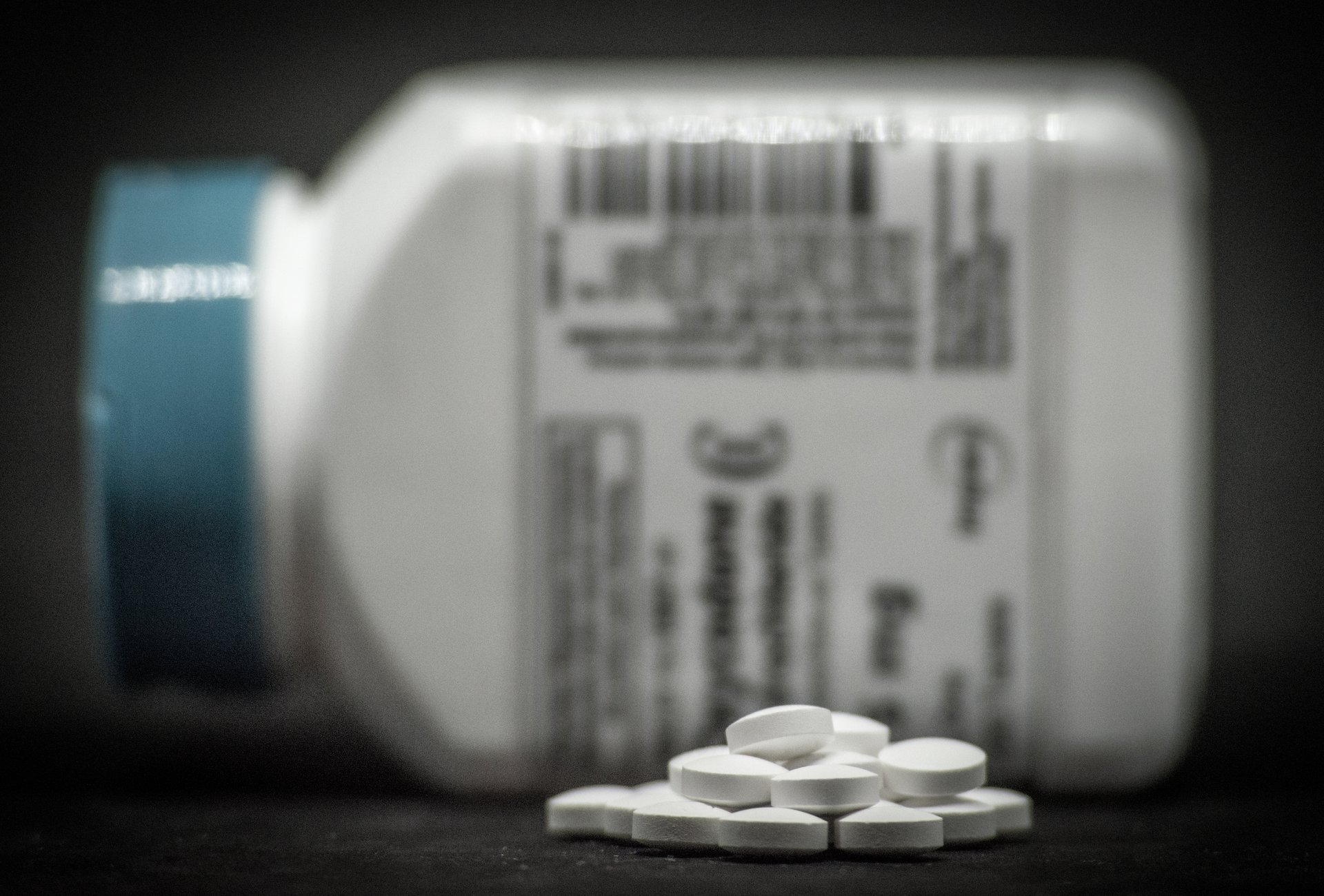 Pill bottle on side with blurred RX label