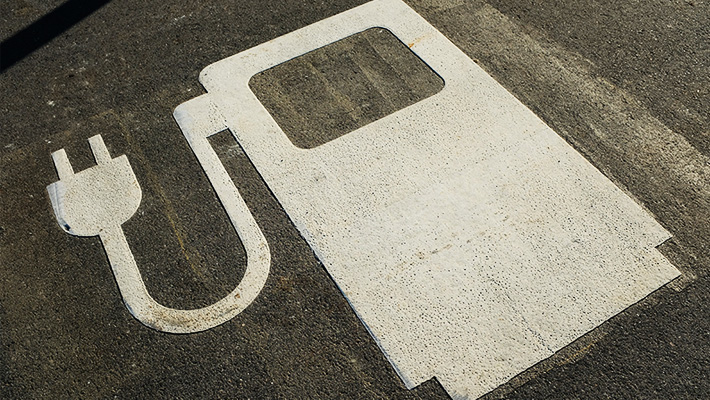 An electric vehicle symbol in a parking lot.