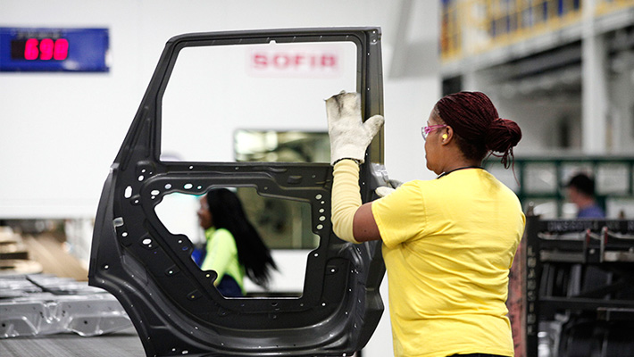 A woman works on a door at the Fiat Chrysler plant in Warren, Michigan.