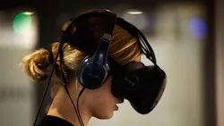 A woman wears an HTV Vive VR headset. A woman wears an HTV Vive VR headset.