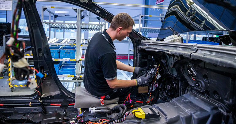 guy working on Mercedes at Germany factory
