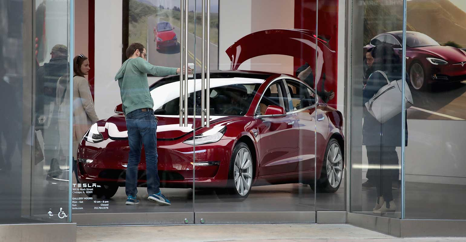 Red Tesla Model 3 in showroom