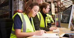 Staff managing warehouse logistics Staff managing warehouse logistics