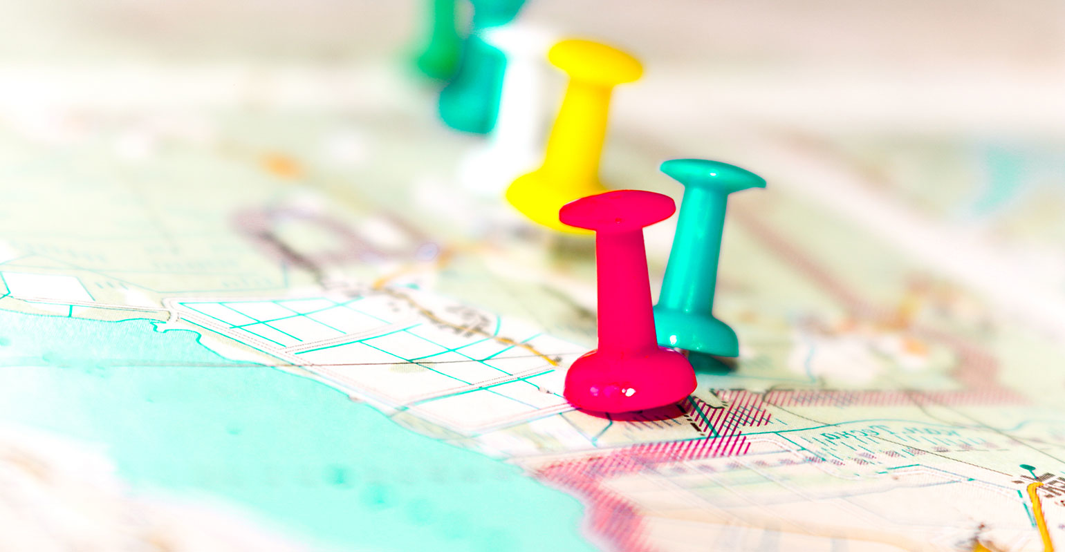 close up of map with pins in it