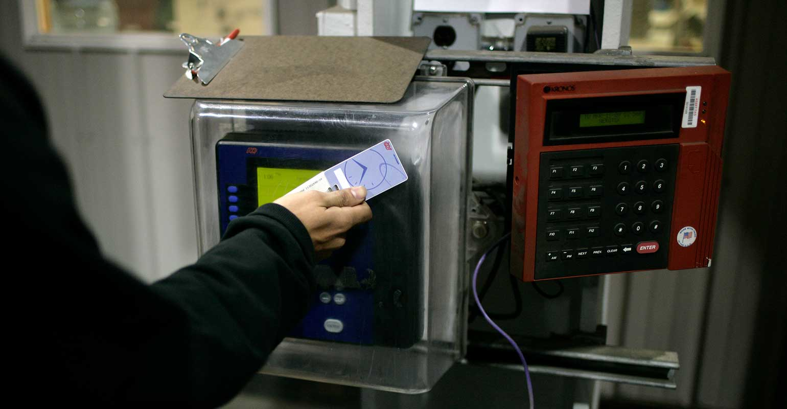 factory-time-card-scanner-brooks-kraft-llc-corbis-getty-images.jpg