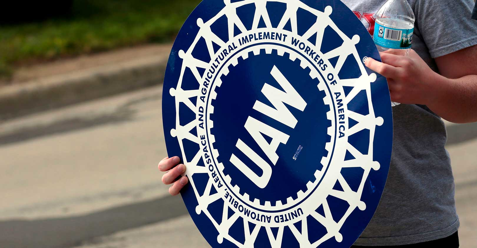 UAW-striker-holds-logo-sign-JEFF-KOWALSKY-AFP-Getty-Images.jpg