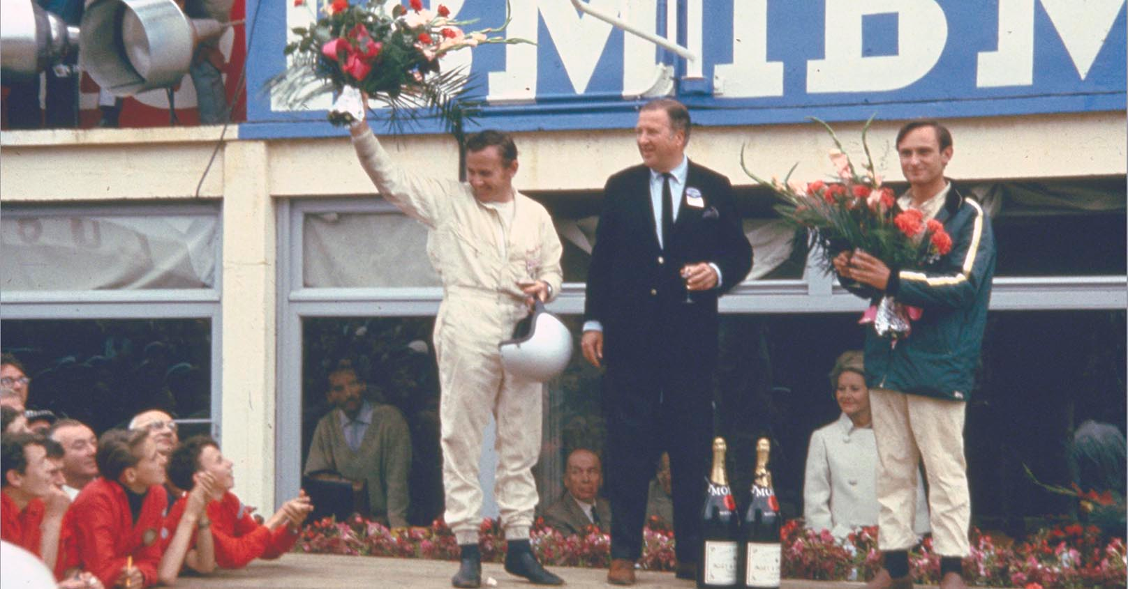 Bruce McLaren, Henry Ford II and Chris Amon on the victory rostrum at 24 Hours of Le Mans 1966.