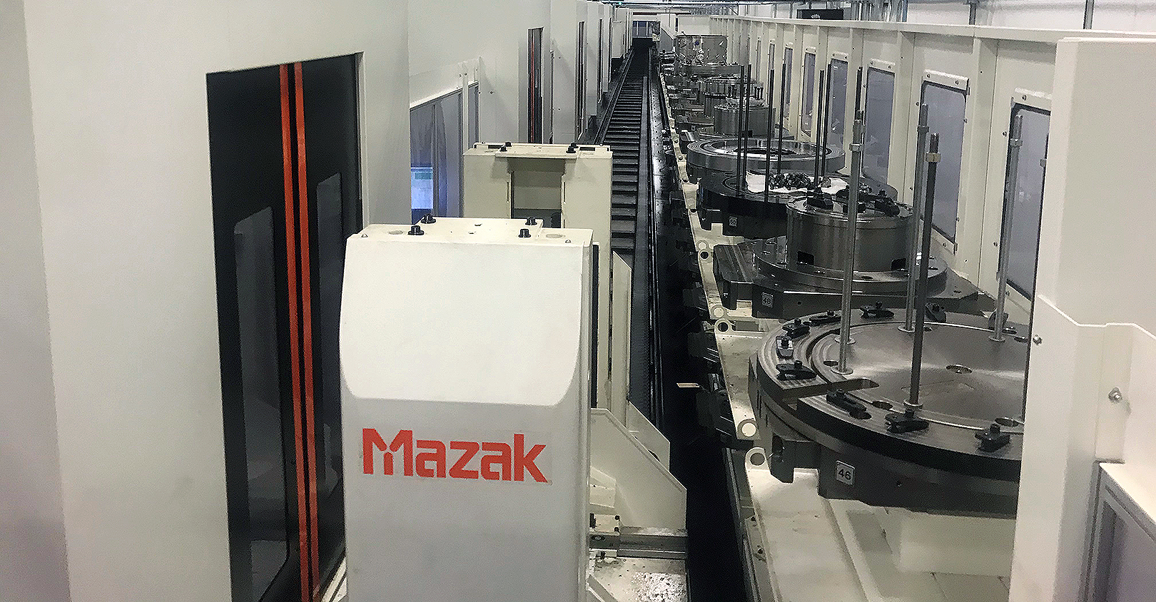 Automation is key to Polamer Precision's talent strategy. Here, a Palletech system runs parts through everything from machining to QA without human interaction, allowing just four operators to tend 11 different machines simultaneously.