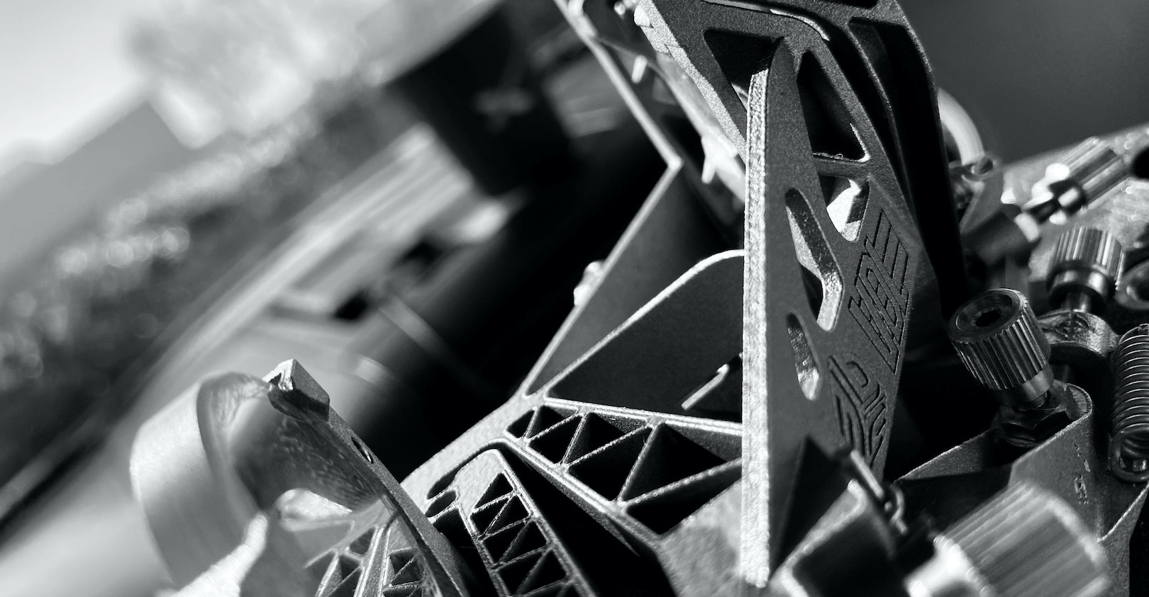 Lightweighting semiconductor components and advanced motion mechanisms reduces inertia and improves lithography and wafer processing machine speed and uptime.