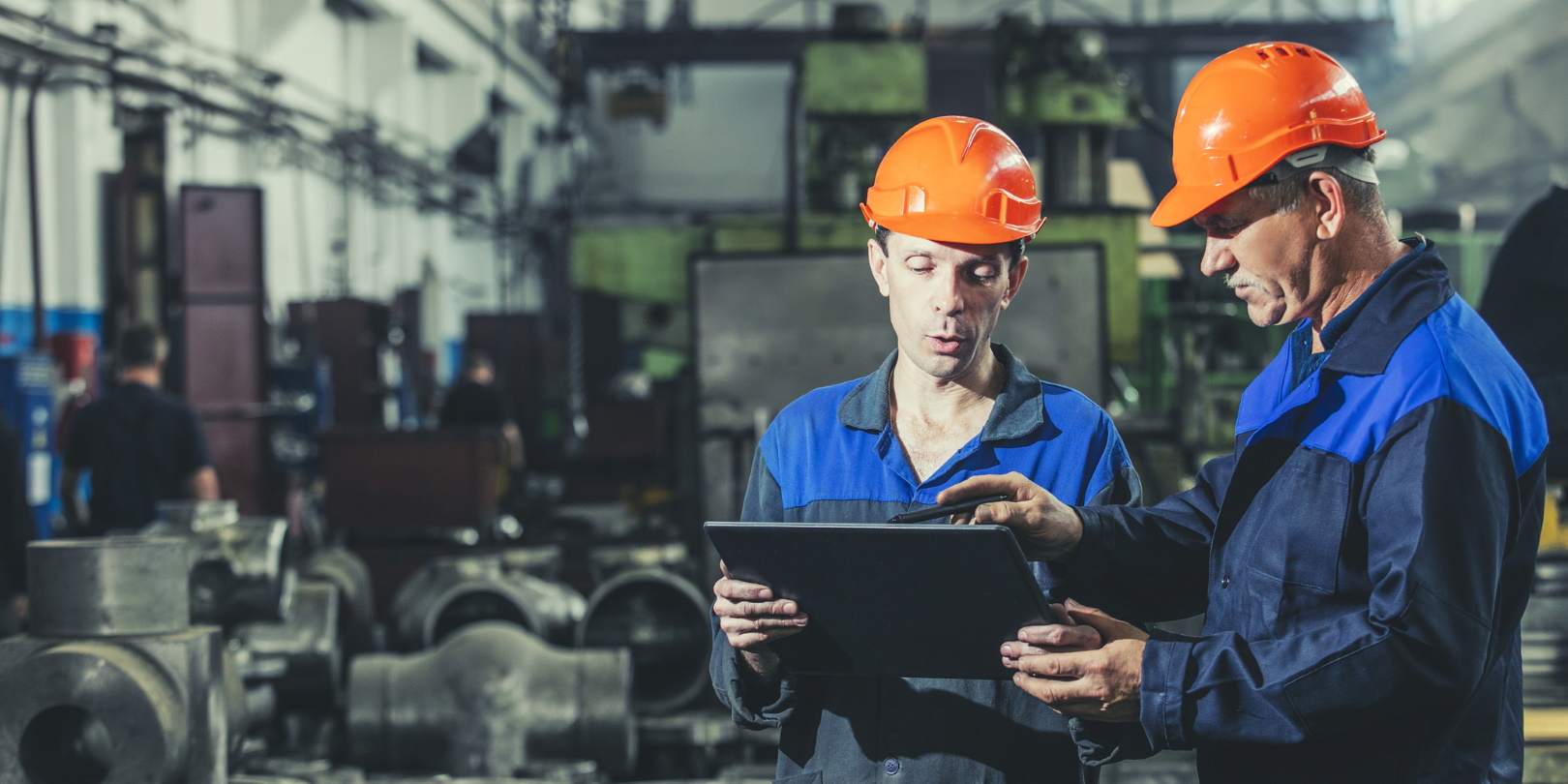 Two Workers At An Industrial Plant With A Tablet In Hand Working Together Manufacturing Activities Evgeniia Kuzmich Dreamstime 613047caad1a2
