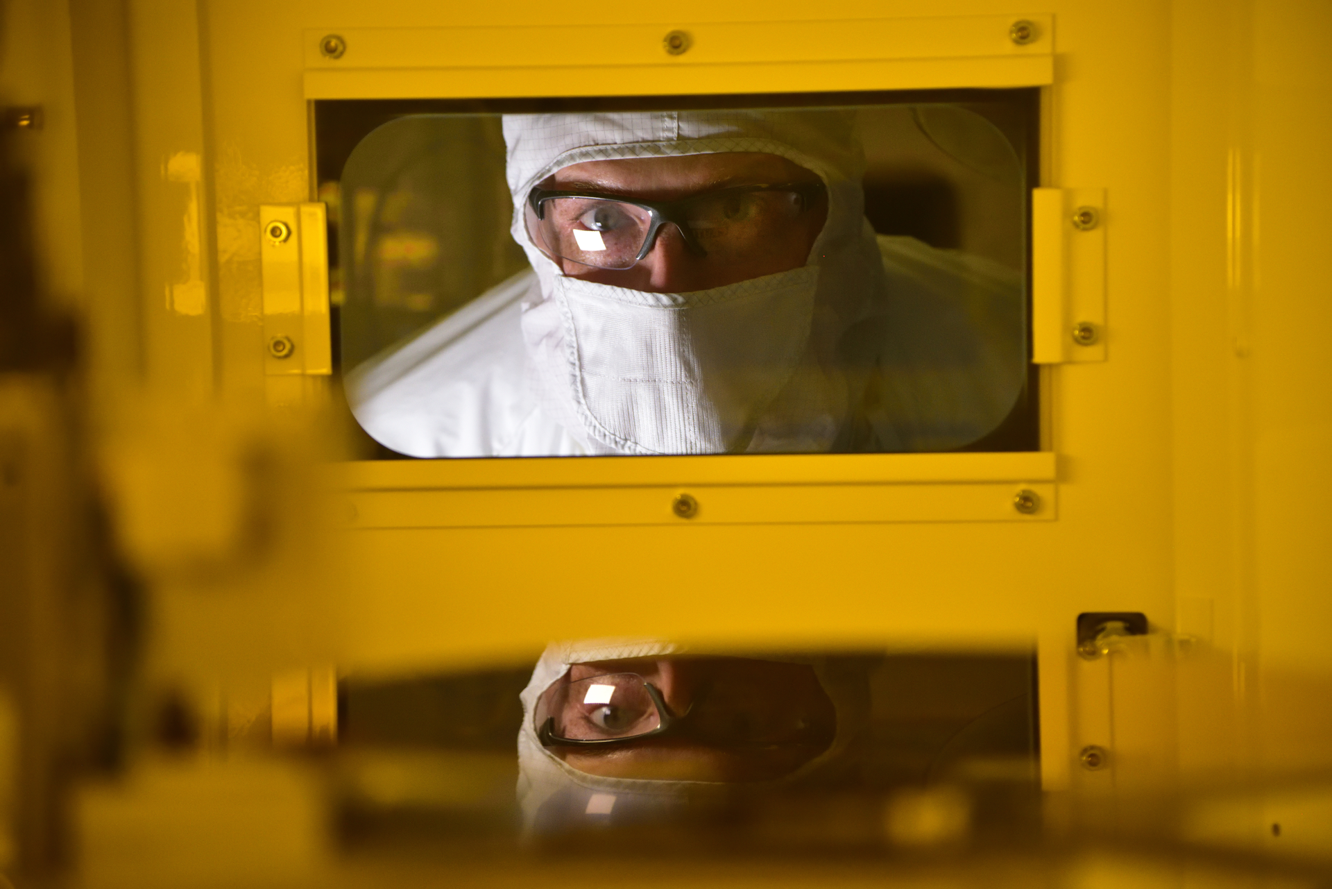 An Intel production worker in Hillsboro, Oregon, produces semiconductors in a cleanroom environment.