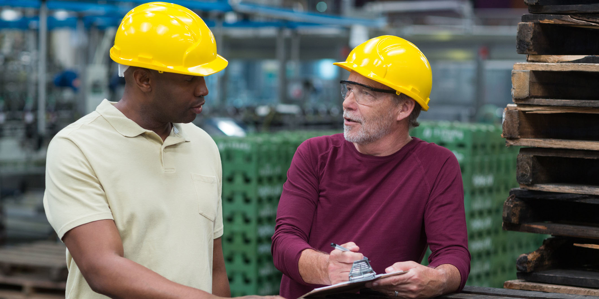 Workers In Beverage Plant Discuss Clipboards Wavebreakmedia Ltd Dreamstime 63dd7eb2cc444