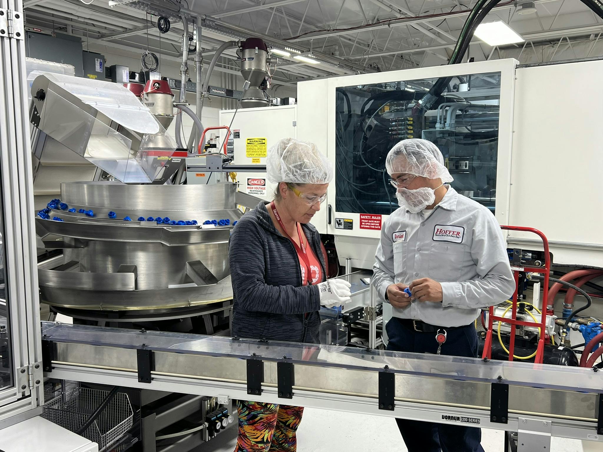 Employees inspect parts at Hoffer Plastics.
