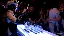 A Telsa Optimus robot hands out gift cards at a recent Hollywood event. Though CEO Elon Musk has called the humanoid robots autonomous, human handlers managed the robots via remote control during the event. A Telsa Optimus robot hands out gift cards at a recent Hollywood event. Though CEO Elon Musk has called the humanoid robots autonomous, human handlers managed the robots via remote control during the event.