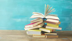 Stack of books against light blue background. Stack of books against light blue background.