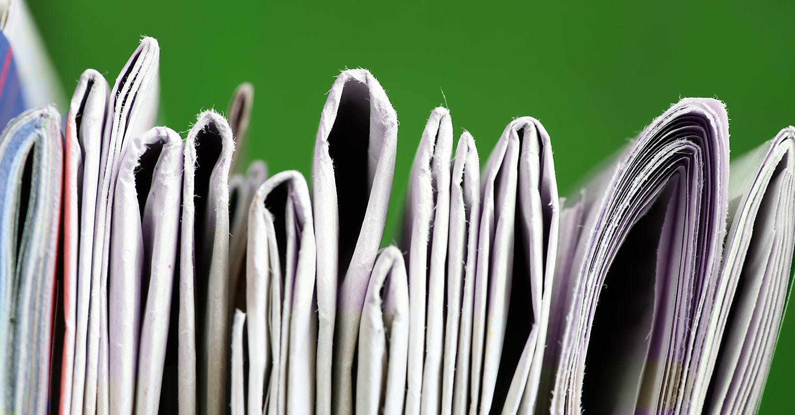 newspapers or magazines stacked horizontally