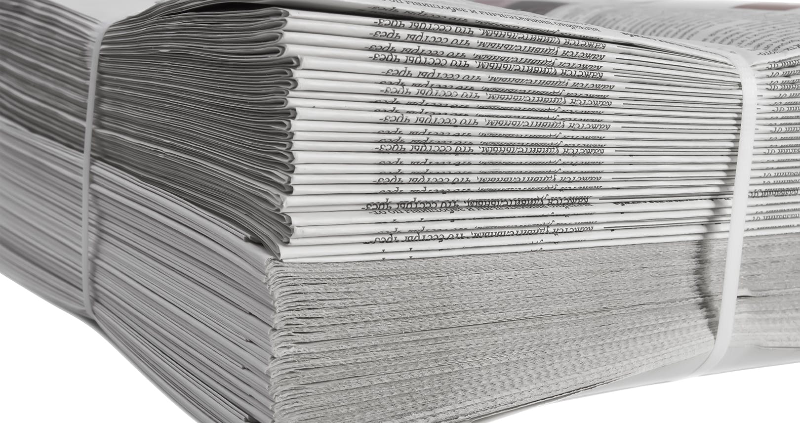 Thick stack of newspapers with bank around them.