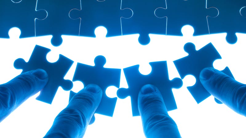 puzzle pieces being pushed into place