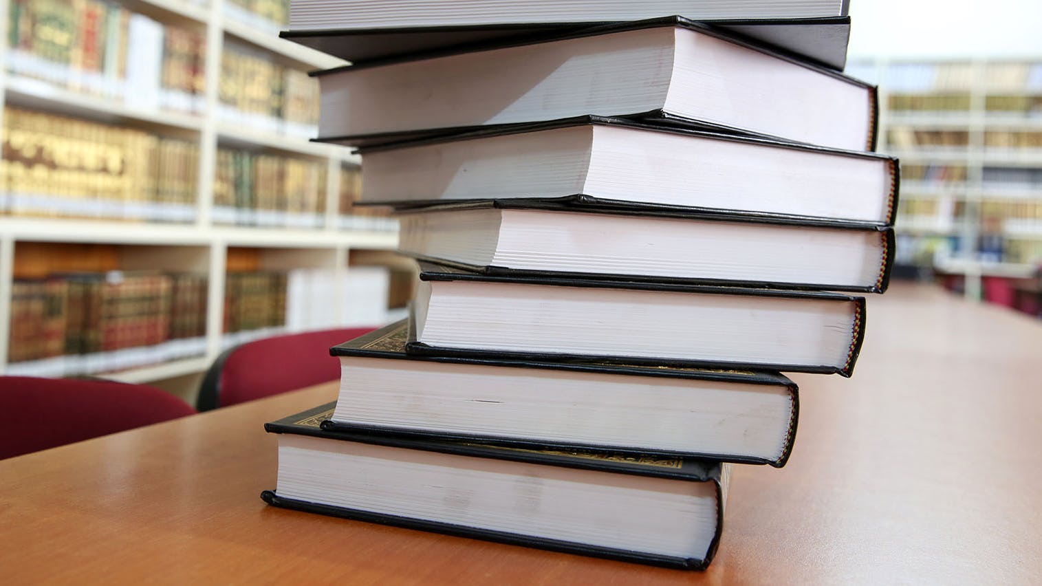 stack of books on library table