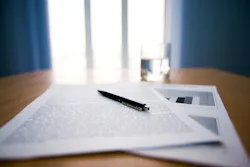 Image of workplace with focus on papers and pen on the table Image of workplace with focus on papers and pen on the table