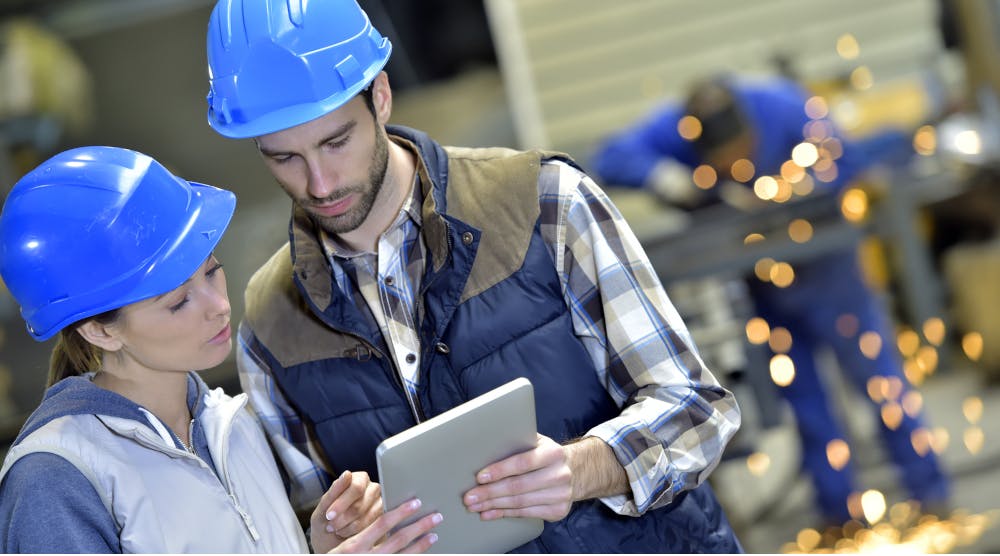 factory_workers_holding_digital_tablet