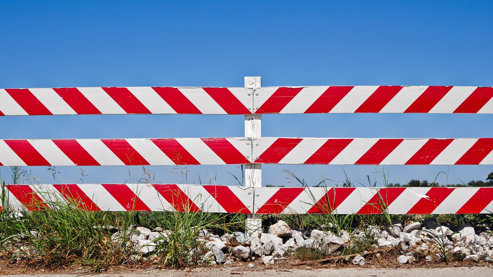 red and white striped fence