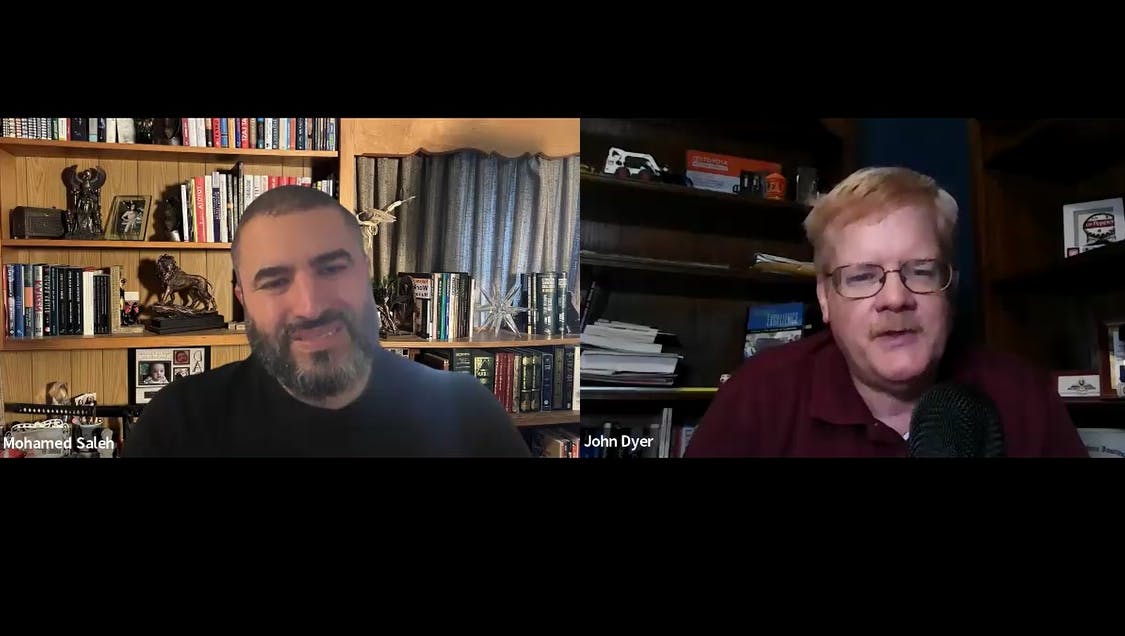 Mohamed Saleh on left speaks with John Dyer on right.