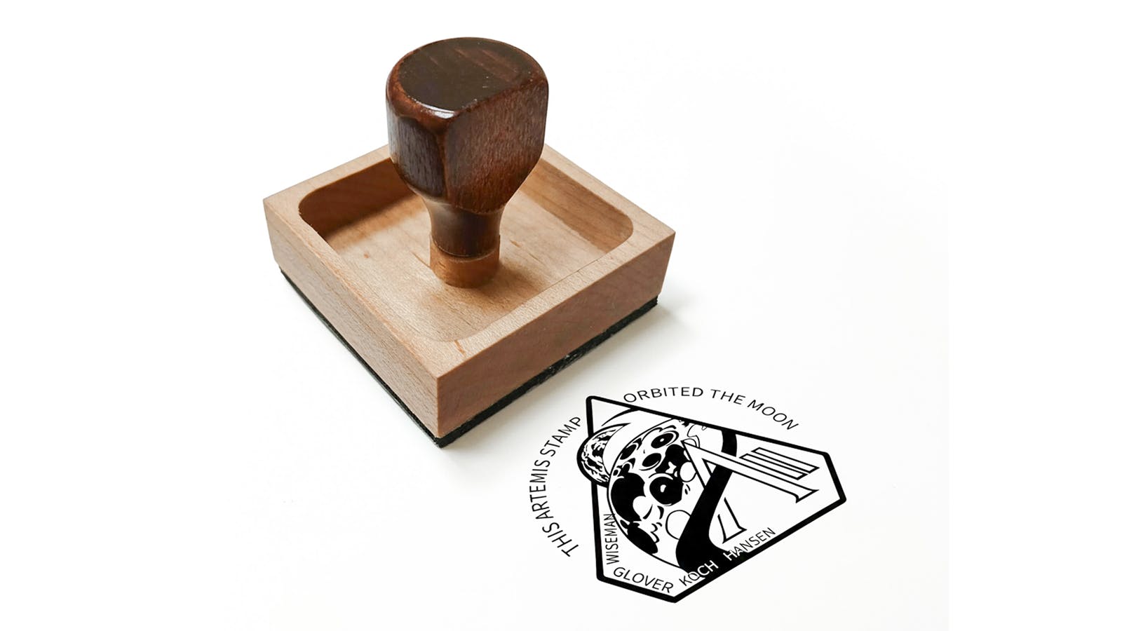 wooden rubber stamp and logo of Artemis II mission