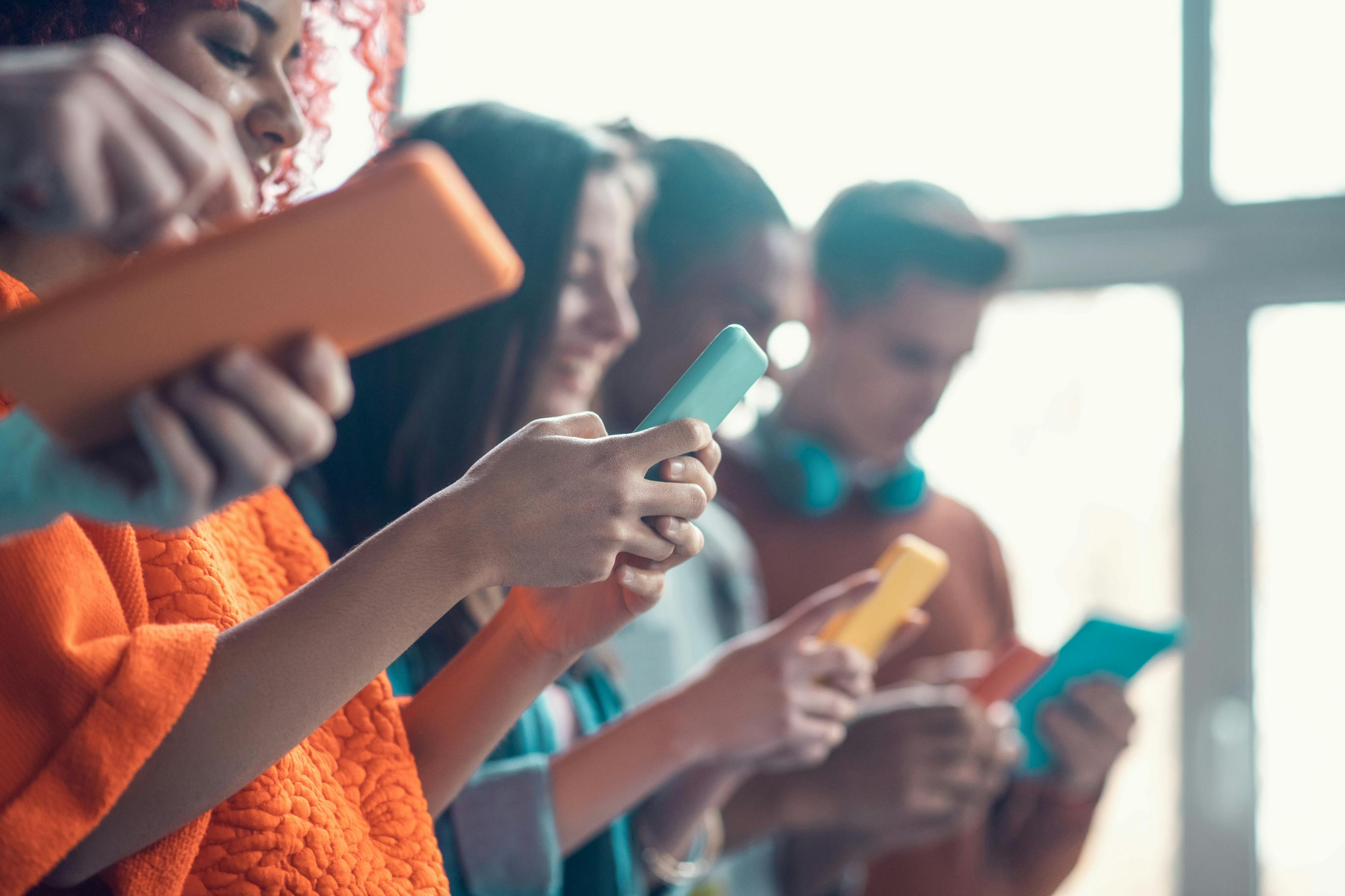 Students Holding Colorful Smartphones While Having Break From Study Colorful Smartphones
