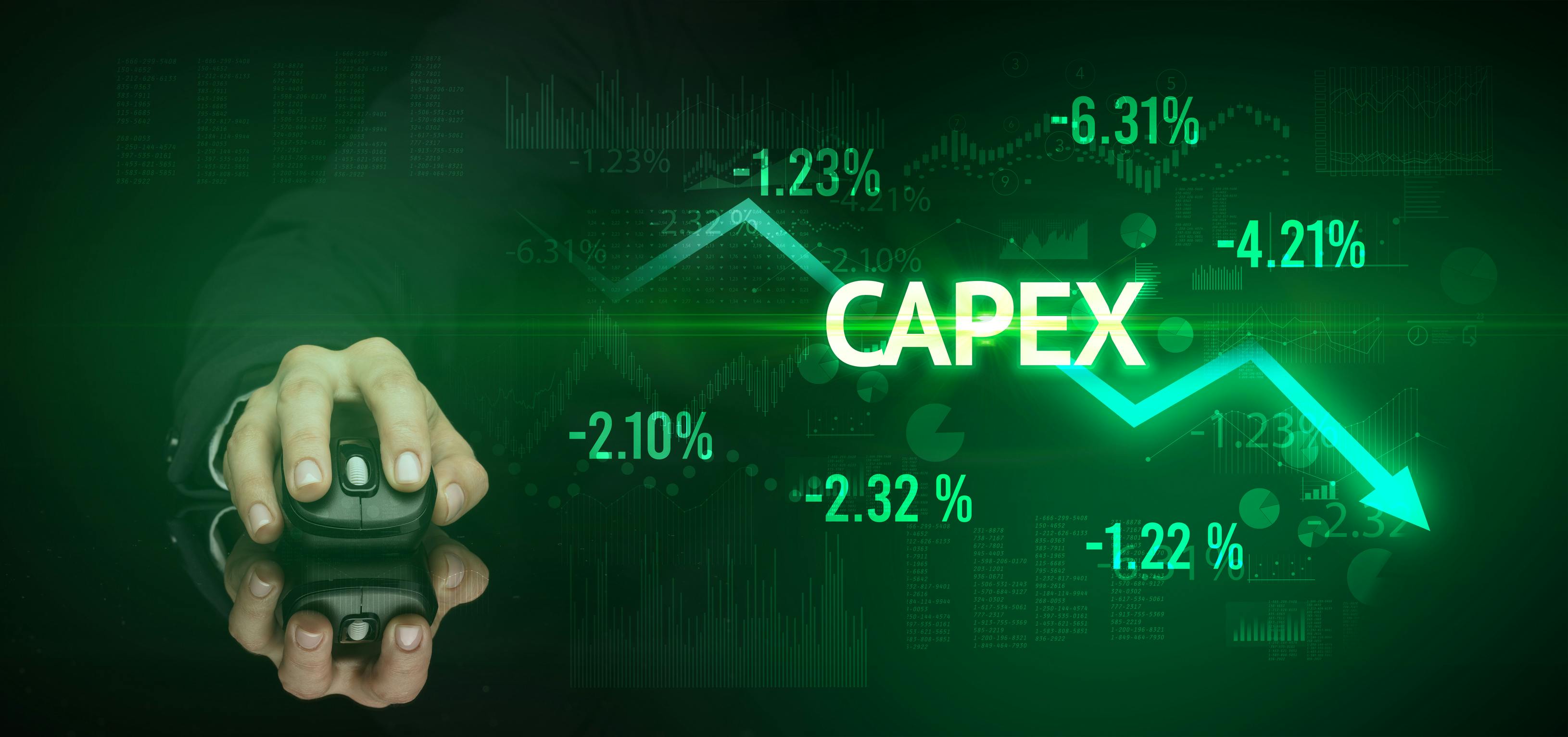 Male hand holding wireless peripheral with CAPEX inscription, modern business concept