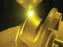 FIGURE 2. The LENS powder-fed process repairing an industrial pump. FIGURE 2. The LENS powder-fed process repairing an industrial pump.