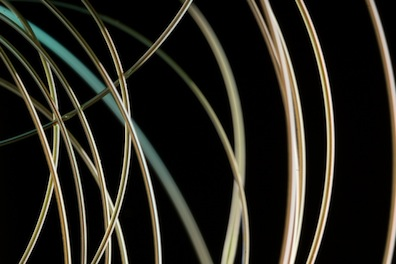 A new fiber developed at MIT emits blue laser light only at a precisely controlled location.