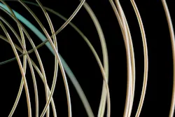 A new fiber developed at MIT emits blue laser light only at a precisely controlled location. A new fiber developed at MIT emits blue laser light only at a precisely controlled location.