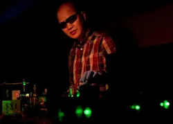 Cuong Dang of Brown University manipulates a green laser beam that pumps quantum dots, in this case producing red laser light. Cuong Dang of Brown University manipulates a green laser beam that pumps quantum dots, in this case producing red laser light.