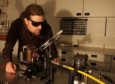Bernd Heinen works on a semiconductor disk laser jointly developed by Marburg, Germany and Tucson, AZ researchers that achieved a record 100 W output.