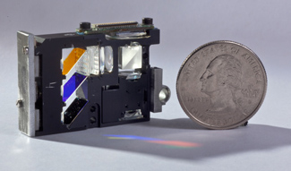 This picoprojector contains optics that convert almost 90% of the unpolarized input light from an LED into output polarized light.