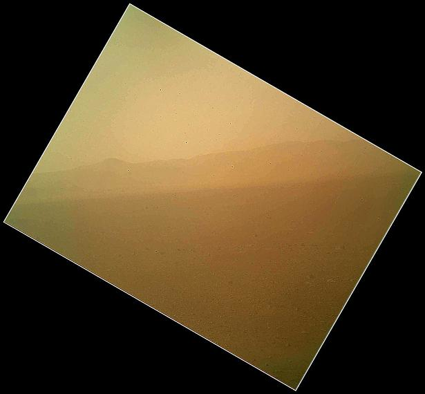 The landscape is shown to the north of NASA's Mars rover Curiosity in this first image acquired by the Mars Hand Lens Imager (MAHLI), revealing the north wall and rim of Gale Crater. The image is murky because the MAHLI&rsquo;s removable dust cover is apparently coated with dust blown onto the camera during the rover's terminal descent. The dust cover will be removed in the coming weeks.