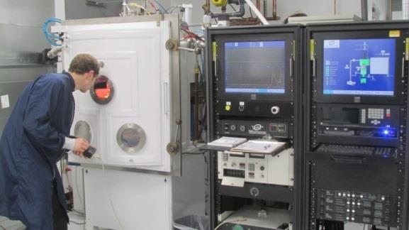 New optical coating chamber is part of Optimax's expanison.