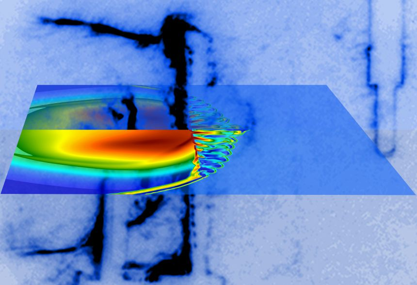 Laser beams illuminate a small carbon rod and launch an asymmetric shock inside a chamber filled with argon gas. A grid is placed in the shock's path, 1 cm from the target, resulting in turbulent flow. The shock and the turbulent flow is captured with the Schlieren imaging technique (blue-black hues) at 300 billionth of a second after the laser shot. The electron density predicted by computer simulations (blue-red hues) is superimposed.
